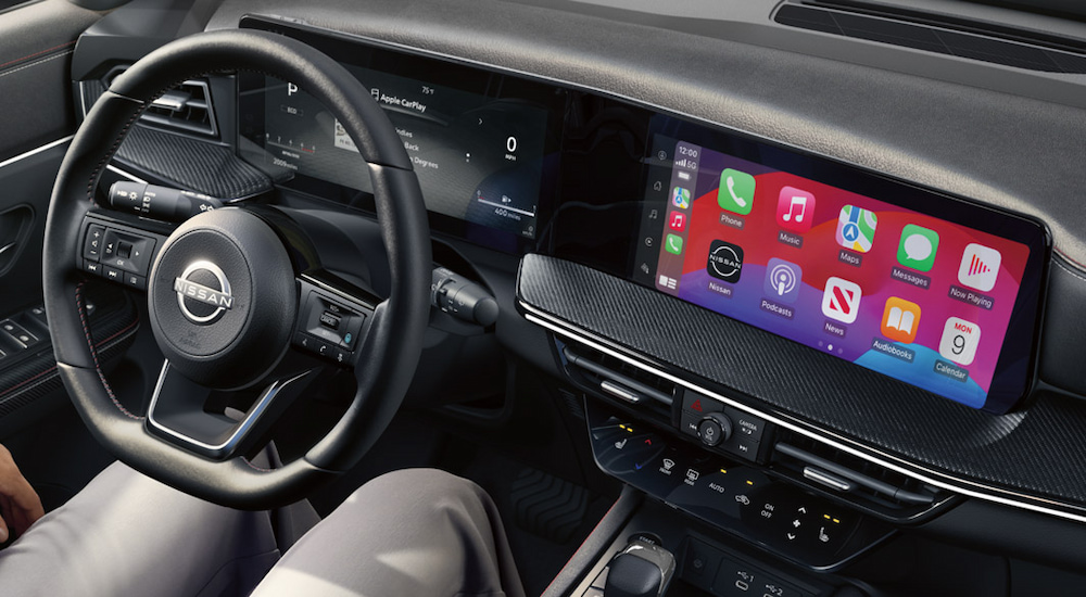 The steering wheel and dual digital display in a 2025 Nissan Kicks.