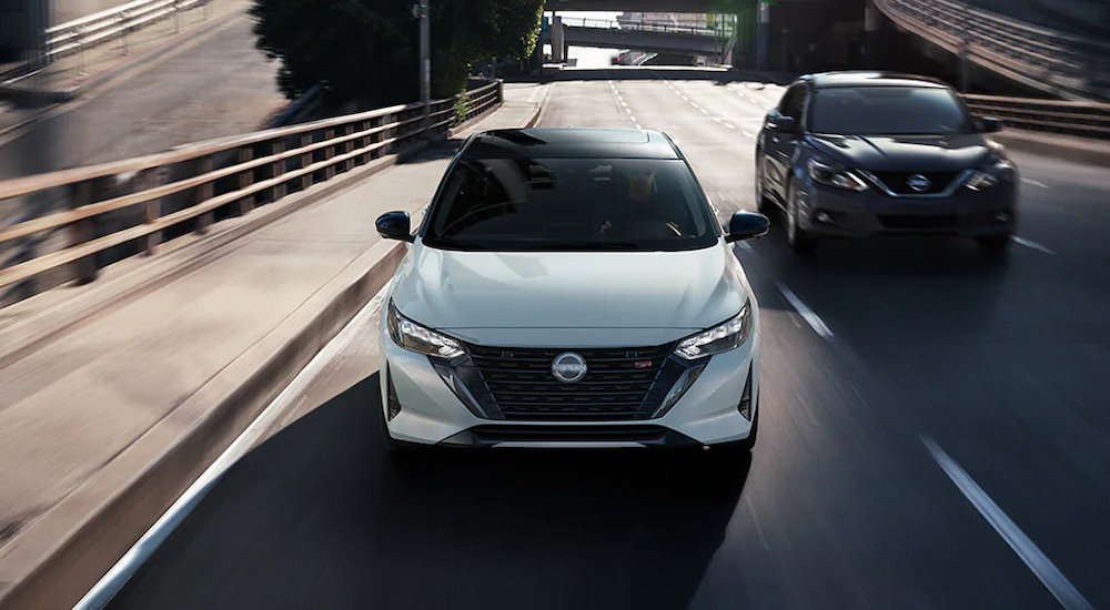 A white 2024 Nissan Sentra SR driving in the city.