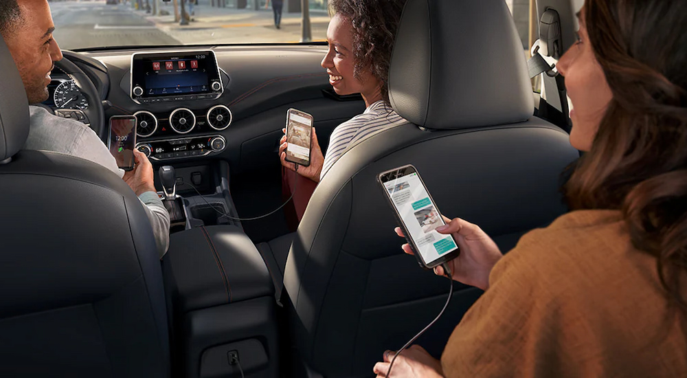 Passengers in a 2024 Nissan Sentra SR utilizing the multiple USB ports to connect their phones.