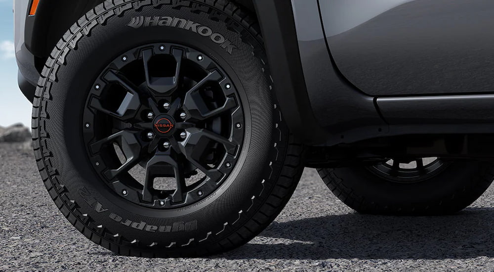 A close-up on the wheels of a grey 2024 Nissan Frontier PRO-4X.