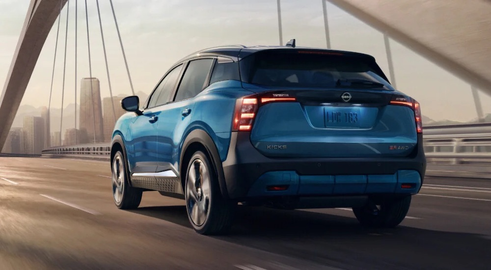 A blue 2025 Nissan Kicks SR is shown from the rear at an angle.