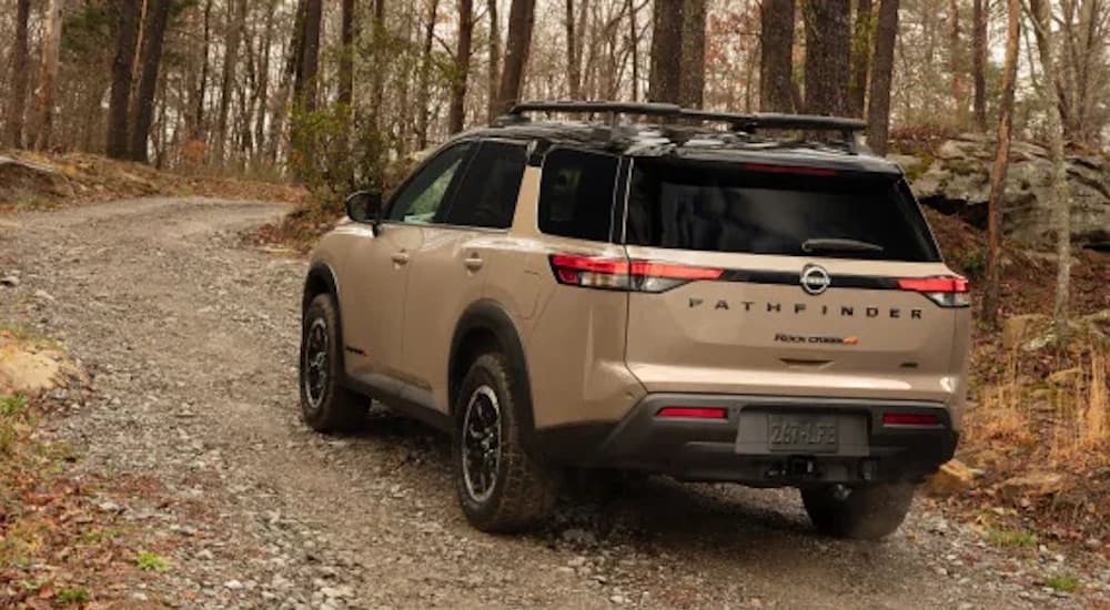 A brown 2025 Nissan Pathfinder Rock Creek is shown from the rear at an angle.