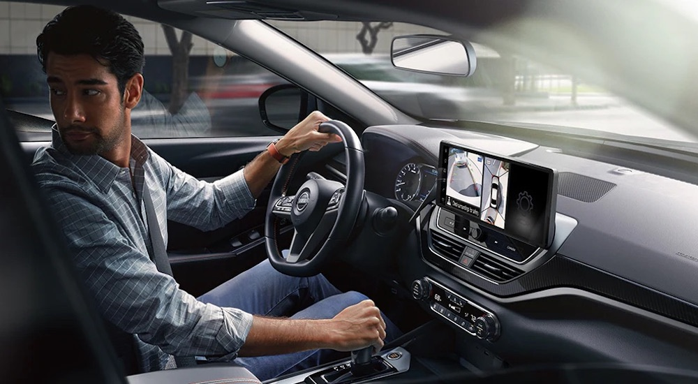 The black interior of a 2025 Nissan Altima is shown from the passenger side.