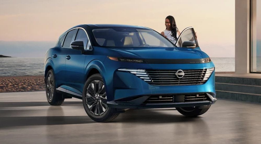 A blue 2025 Nissan Murano parked near water.