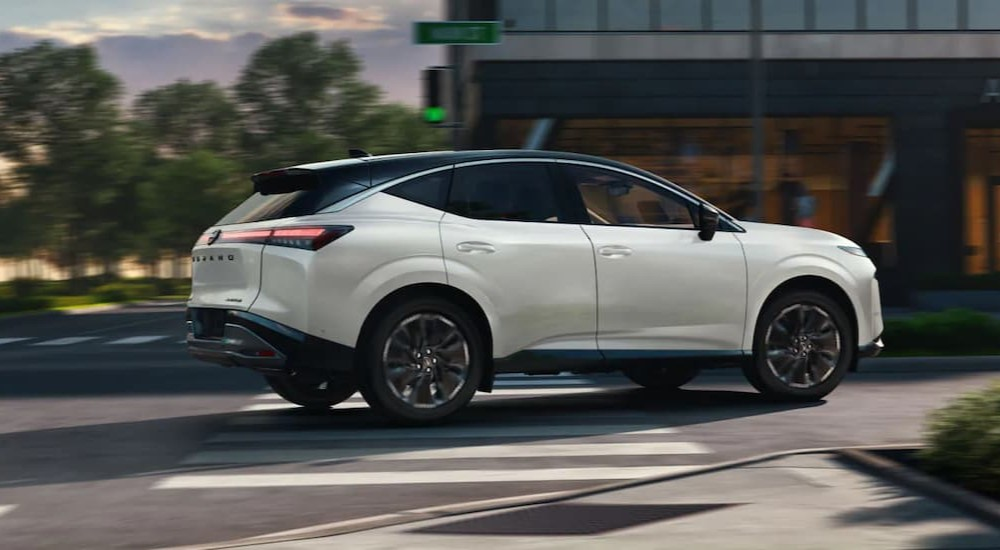 A white 2025 Nissan Murano driving in a city.