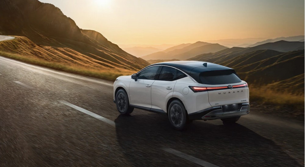 A white 2025 Nissan Murano driving on a highway.