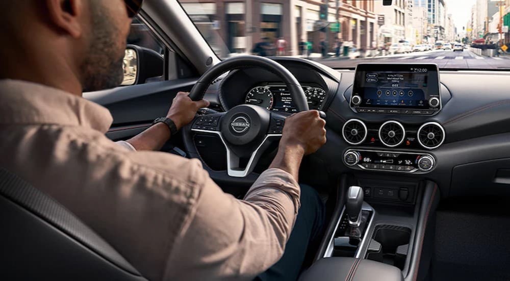 A person driving in a 2025 Nissan Sentra for sale in Knoxville.