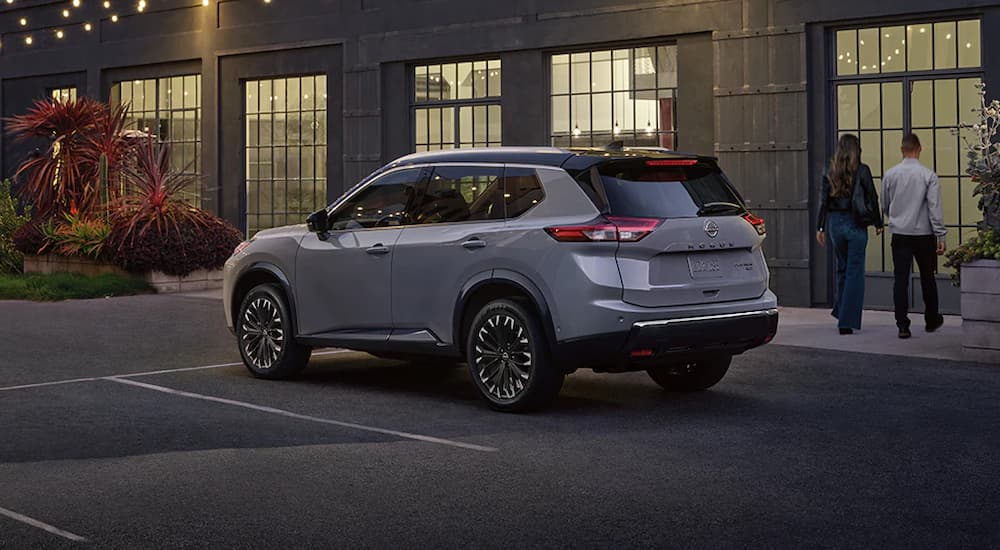 A gray 2025 Nissan Rogue parked outside a building