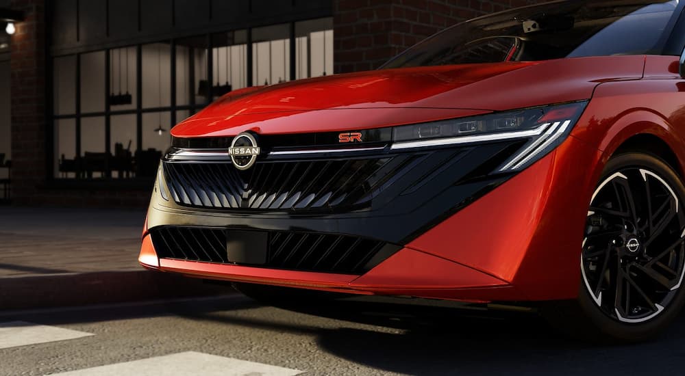 Headlights on a red 2026 Nissan Sentra SR parked in a city