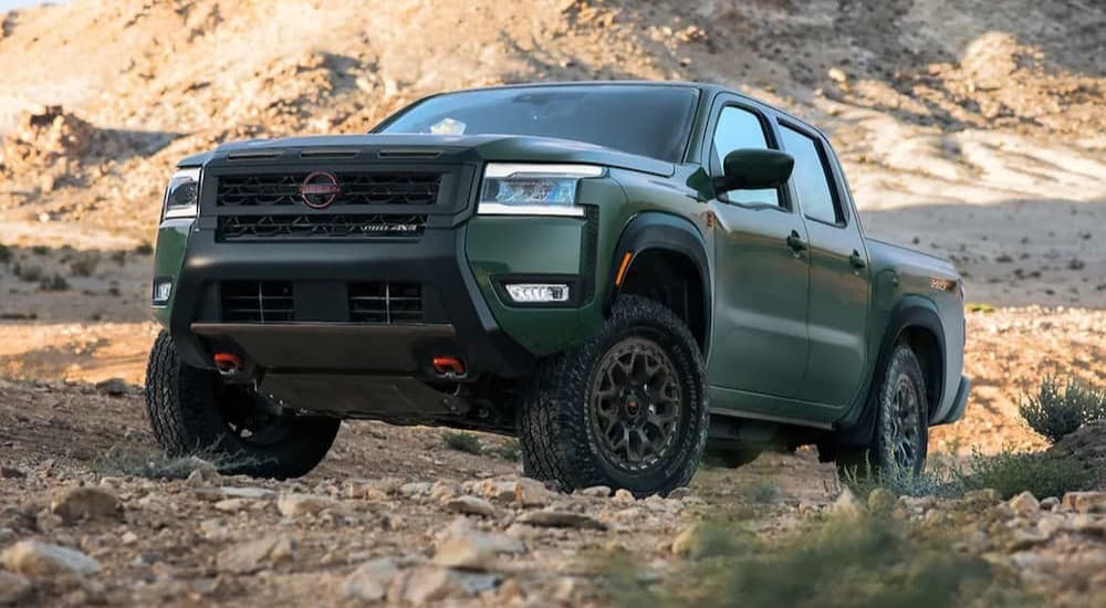 A green 2026 Nissan Frontier Pro-4X is parked off-road.