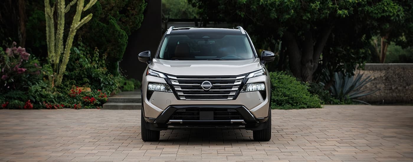 Front of a grey 2026 Nissan Rogue parked off-road.