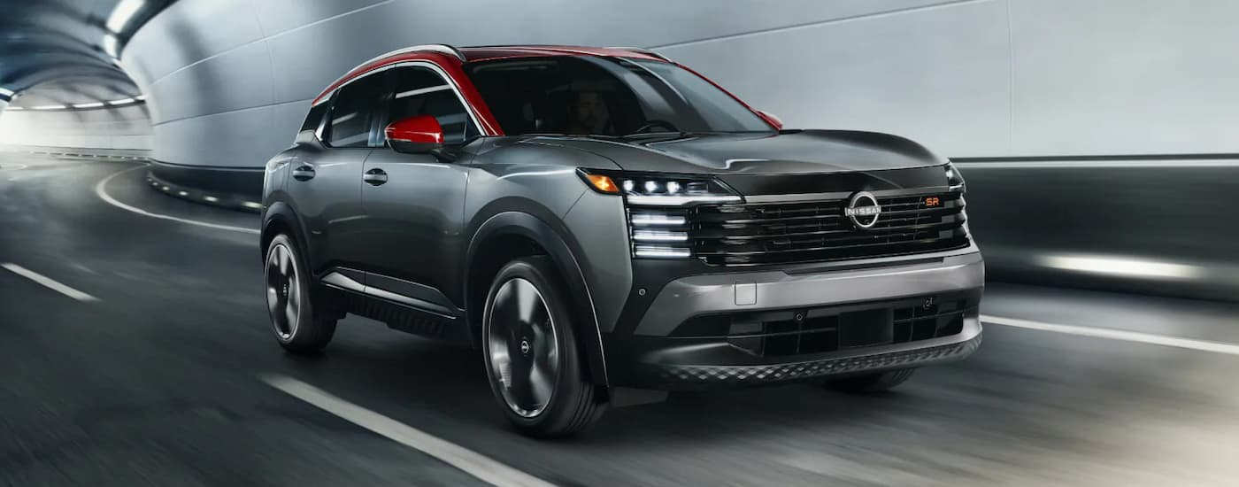 Grey 2026 Nissan Kicks driving down a tunnel.