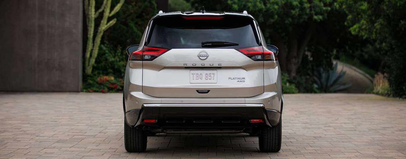 Rear of a grey 2027 Nissan Rogue parked on a pavement.