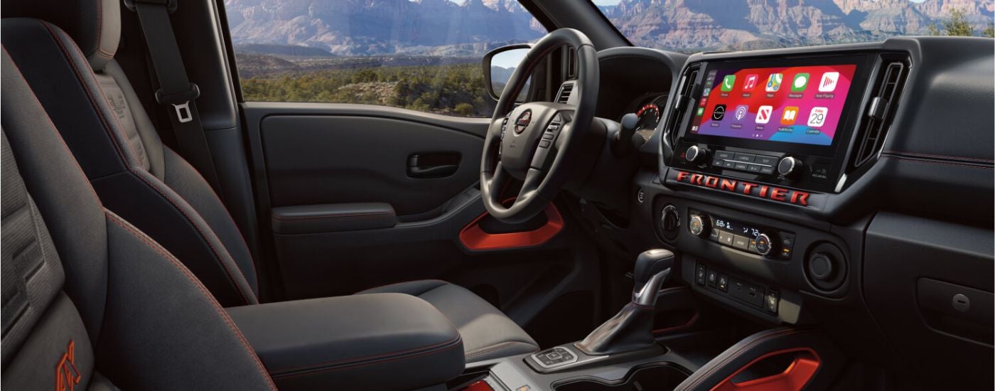 Infotainment display and steering wheel on a 2026 Nissan Frontier PRO-4X.