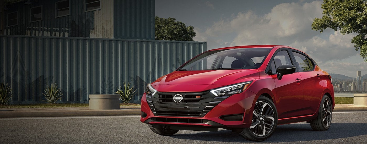 A red 2024 Nissan Versa for sale at a Nissan dealer near Morristown.