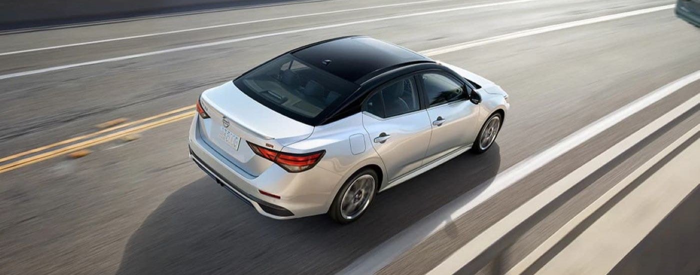 White 2024 Nissan Sentra SR driving down a highway.