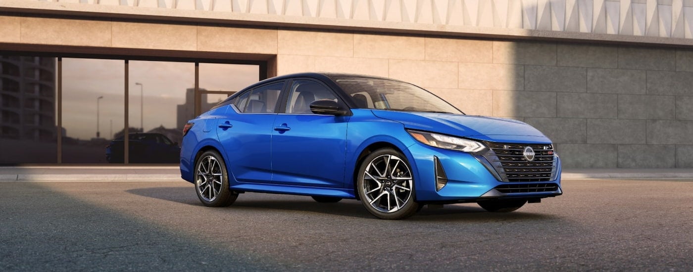 Blue 2025 Nissan Sentra parked outside a building.