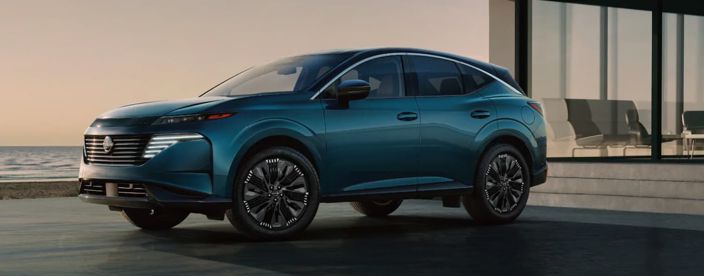 A blue 2025 Nissan Murano parked in a driveway
