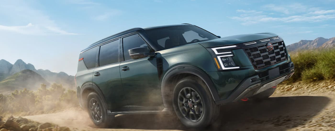 A dark gray 2026 Nissan Armada driving off-road in dirt